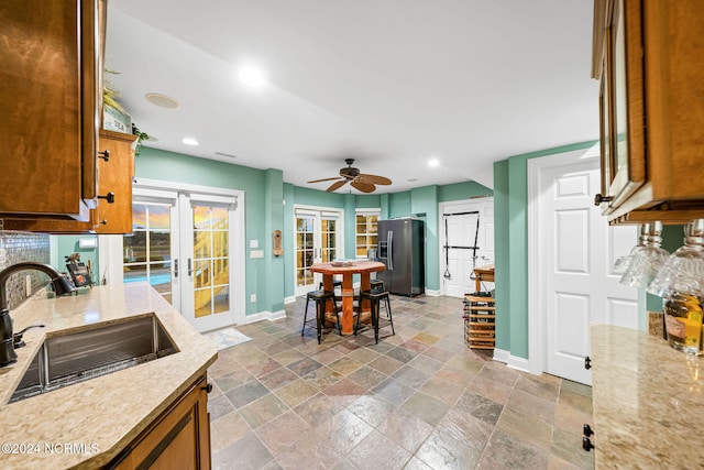 kitchen featuring french doors, ceiling fan, sink, and stainless steel refrigerator with ice dispenser