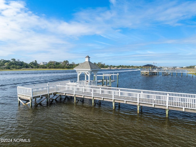 view of dock with a gazebo and a water view