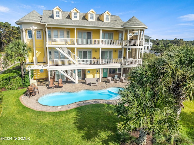 view of swimming pool featuring a yard and a patio area