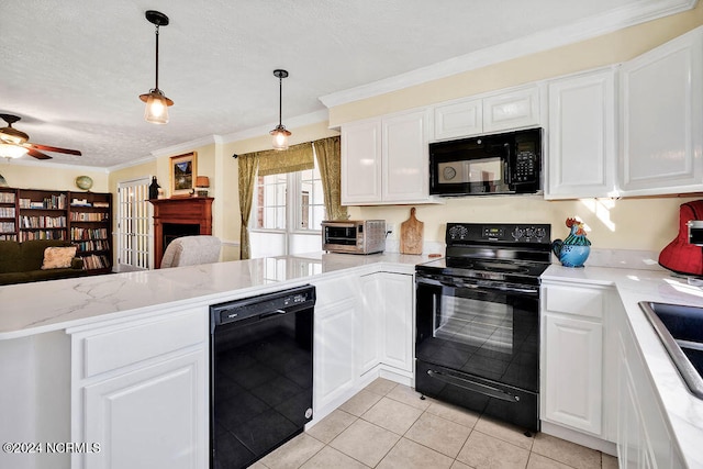 kitchen with pendant lighting, ornamental molding, white cabinets, black appliances, and light tile patterned floors