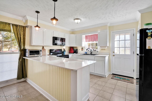 kitchen featuring sink, kitchen peninsula, white cabinetry, and black appliances