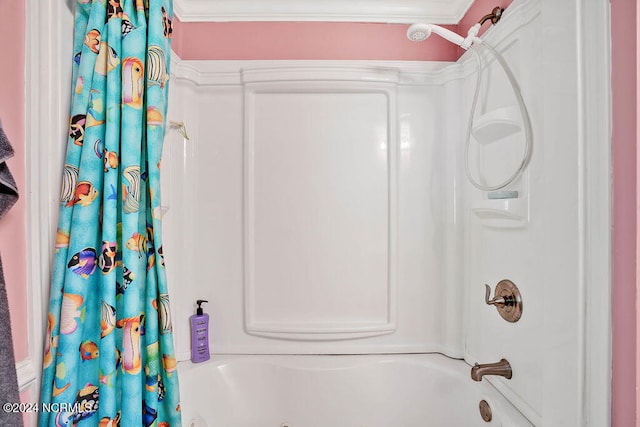 bathroom with ornamental molding and shower / tub combo with curtain