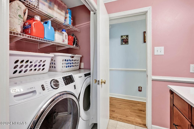 laundry room featuring light hardwood / wood-style flooring and washer and clothes dryer