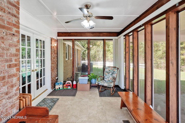 sunroom / solarium featuring ceiling fan and french doors