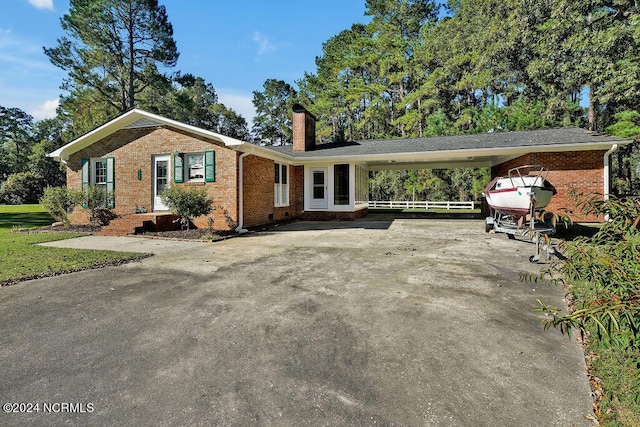 single story home featuring a carport