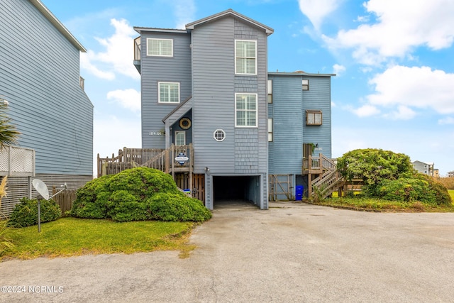 rear view of property with a garage