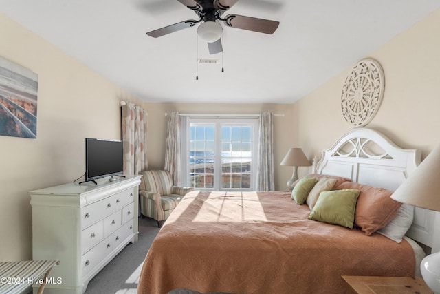 carpeted bedroom featuring ceiling fan and ensuite bathroom