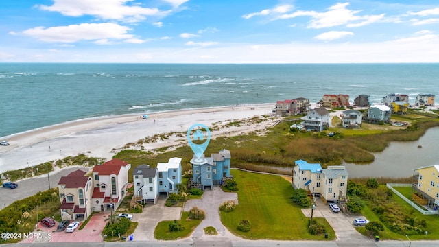 drone / aerial view featuring a water view and a view of the beach