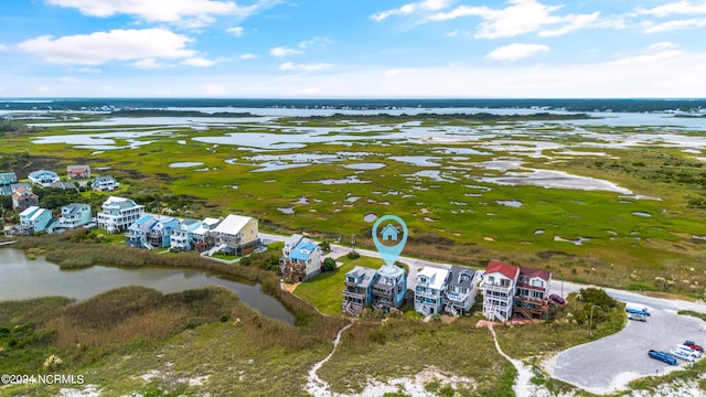 drone / aerial view with a water view and a beach view