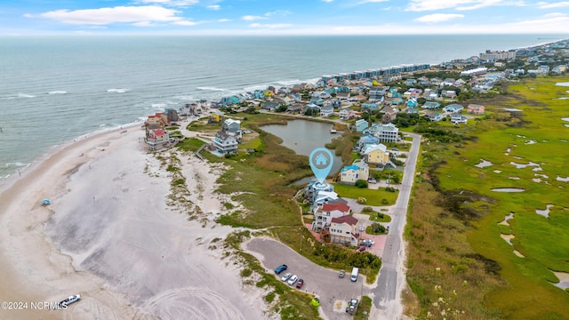 aerial view with a water view and a beach view