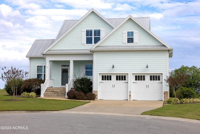 craftsman house featuring a front yard and a garage