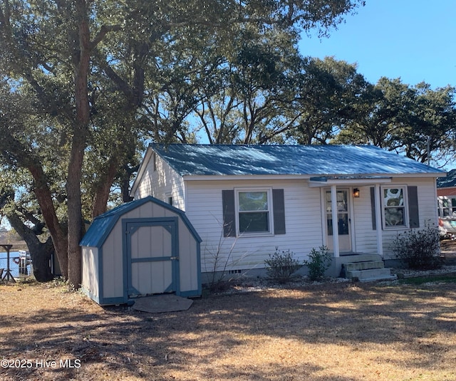 view of front of property with an outbuilding, a storage shed, and crawl space