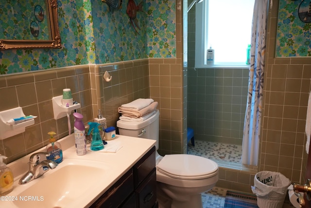 full bathroom with wainscoting, toilet, tile walls, wallpapered walls, and a shower stall