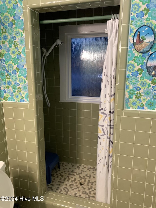 bathroom featuring a shower stall and toilet