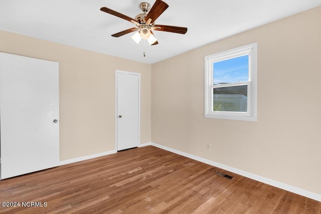 empty room featuring ceiling fan and wood-type flooring