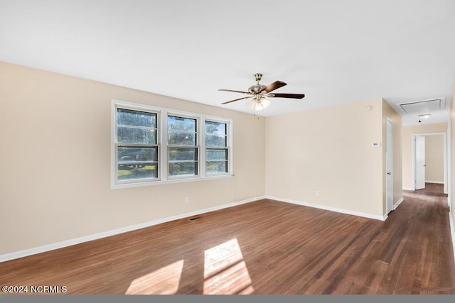 empty room with dark wood-type flooring and ceiling fan