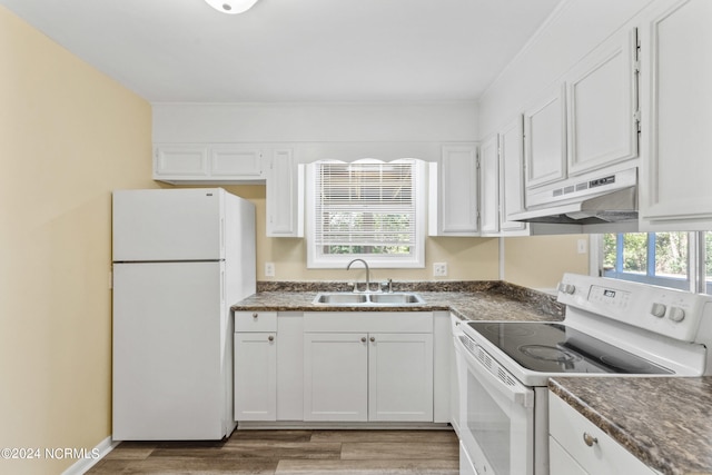 kitchen featuring white appliances, white cabinetry, sink, and hardwood / wood-style floors