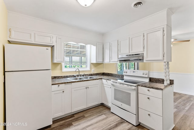 kitchen featuring white appliances, a healthy amount of sunlight, light hardwood / wood-style flooring, and white cabinets