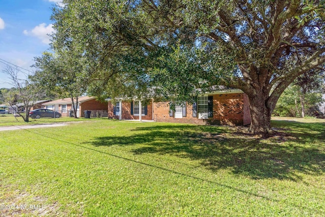 view of front facade featuring a front yard and brick siding