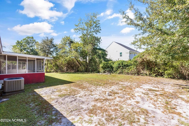 view of yard featuring central AC and a sunroom