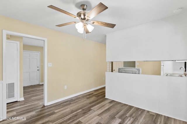 interior space with sink, dark wood-type flooring, and ceiling fan