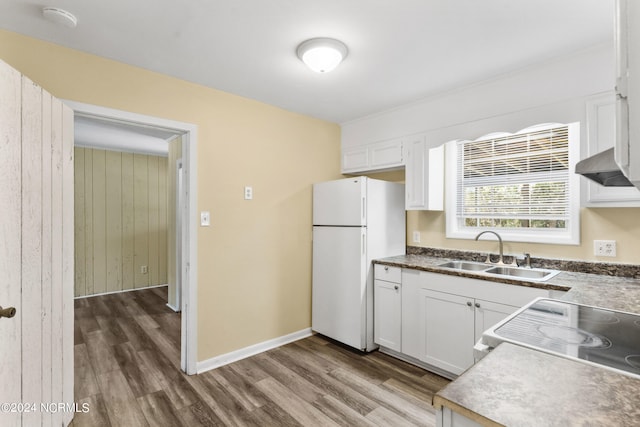 kitchen featuring white cabinets, hardwood / wood-style flooring, sink, and white refrigerator