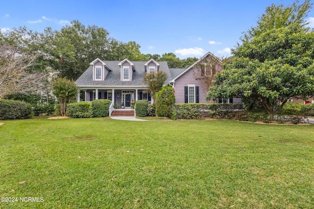 cape cod-style house featuring a porch and a front lawn