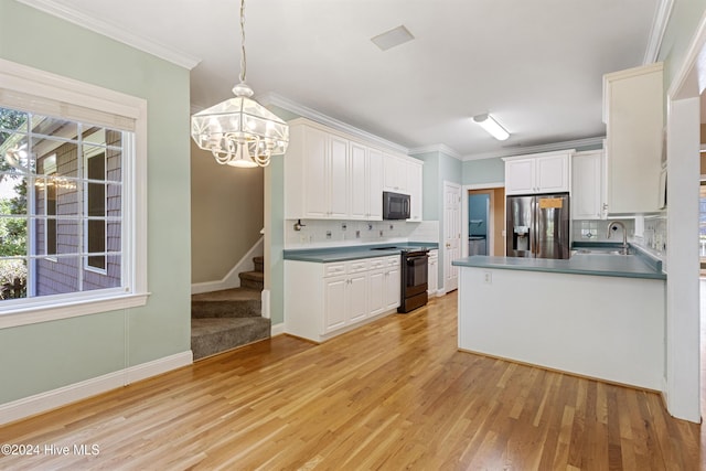 kitchen with backsplash, pendant lighting, white cabinets, black appliances, and ornamental molding