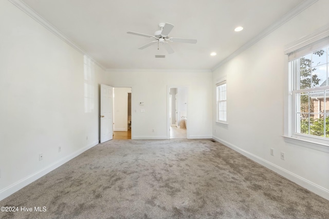 unfurnished room featuring carpet flooring, ceiling fan, and ornamental molding