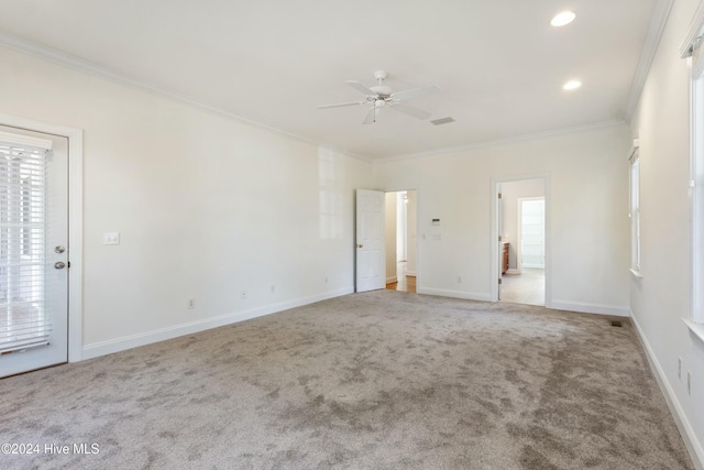 spare room featuring carpet flooring, ceiling fan, and crown molding