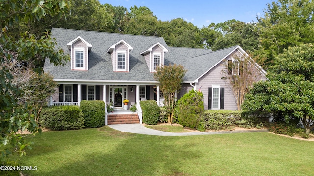 cape cod house with a porch and a front lawn