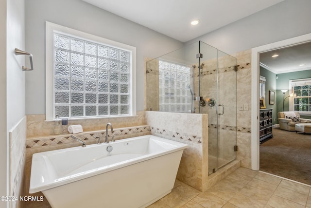 bathroom featuring tile patterned flooring and independent shower and bath