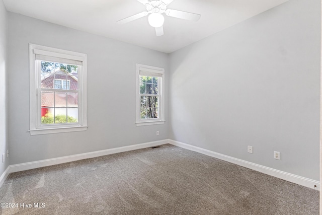 empty room with carpet floors and ceiling fan