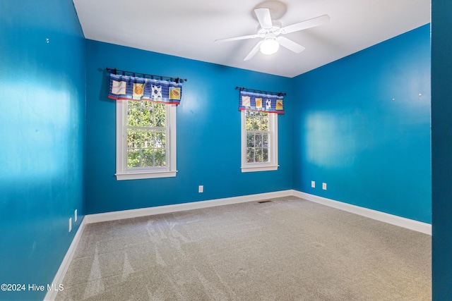 unfurnished room featuring ceiling fan, plenty of natural light, and carpet