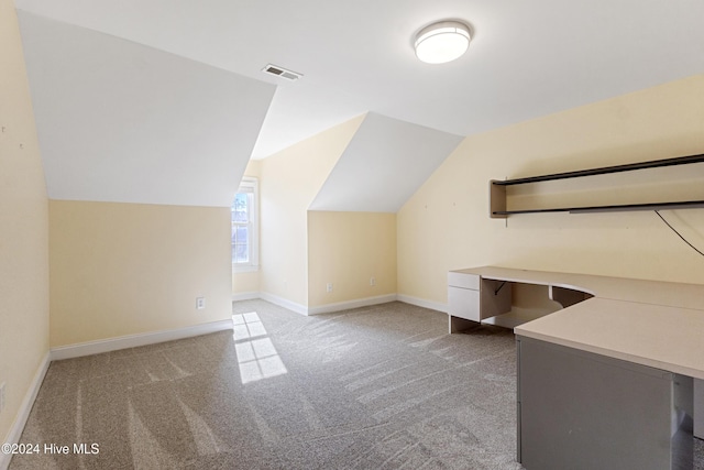 bonus room with lofted ceiling and carpet floors