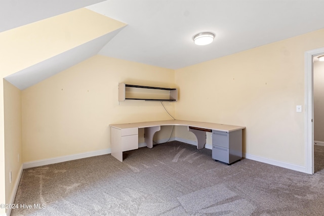 unfurnished office featuring an AC wall unit and light carpet