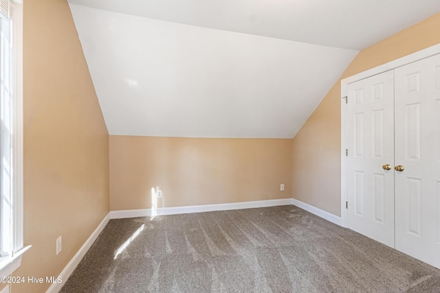 bonus room featuring carpet and lofted ceiling