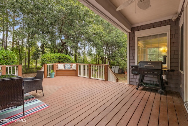 wooden deck featuring ceiling fan and area for grilling