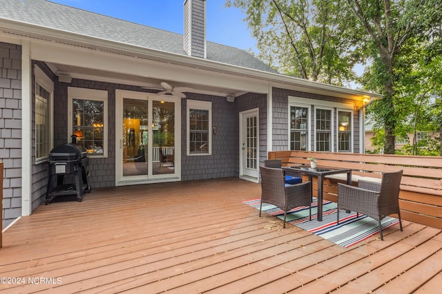 wooden terrace featuring ceiling fan and grilling area