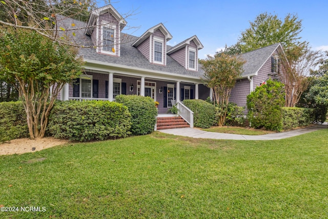 cape cod-style house with a front yard and a porch