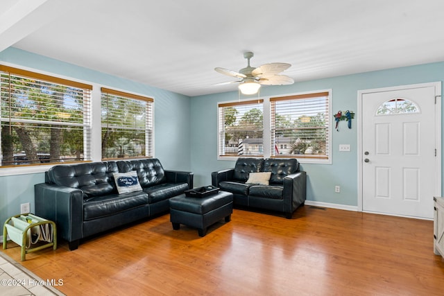 146 NE 5th St, Oak Island, NC 28465 - living area with ceiling fan, a wealth of natural light, and light wood-type flooring