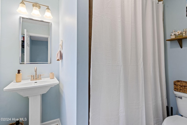 146 NE 5th St, Oak Island, NC 28465 - bedroom with baseboards, a closet, a ceiling fan, and wood finished floors