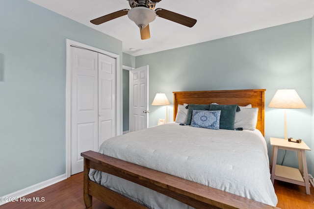 146 NE 5th St, Oak Island, NC 28465 - bedroom with baseboards, multiple windows, a ceiling fan, and wood finished floors