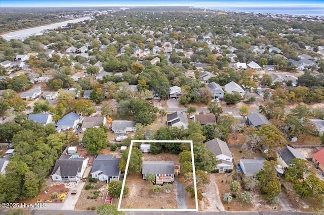 146 NE 5th St, Oak Island, NC 28465 - birds eye view of property featuring a wooded view