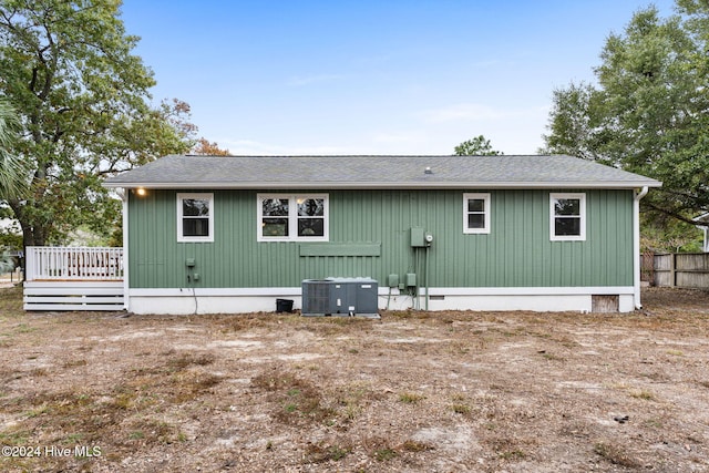 146 NE 5th St, Oak Island, NC 28465 - exterior space featuring central air condition unit, a wooden deck, an outdoor living space, and a fenced in pool