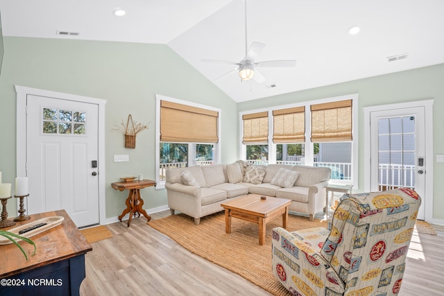 living room with lofted ceiling, ceiling fan, and light wood-type flooring