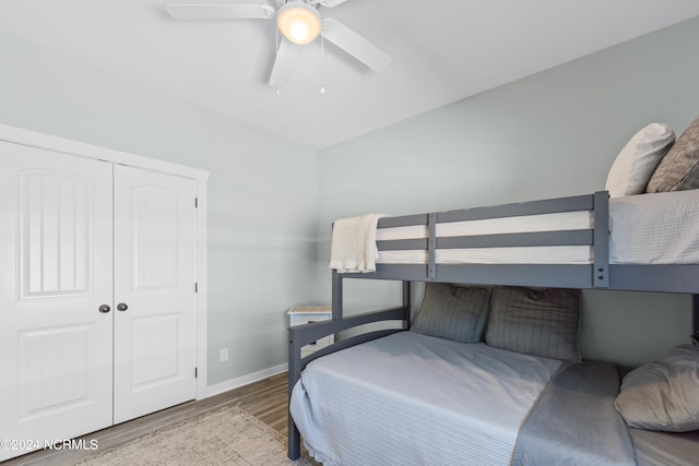 bedroom with ceiling fan, a closet, and hardwood / wood-style floors