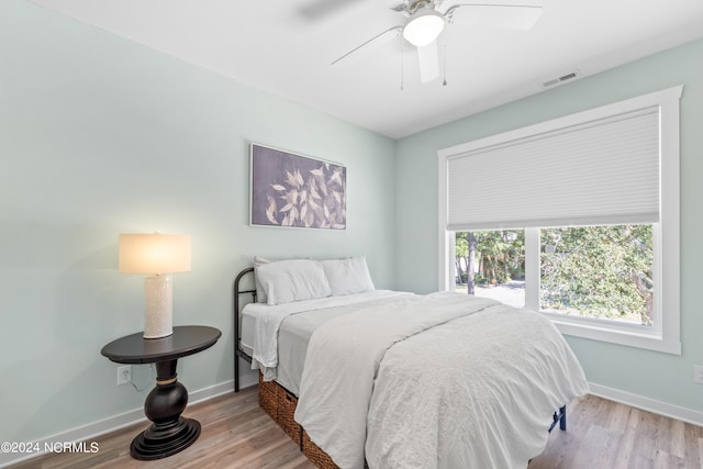 bedroom with light wood-type flooring and ceiling fan