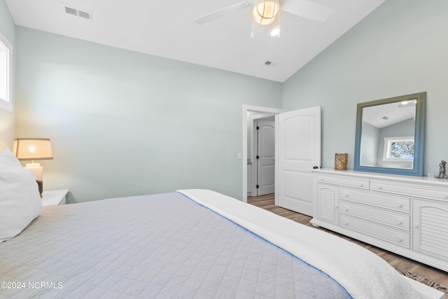 bedroom featuring light wood-type flooring, high vaulted ceiling, and ceiling fan