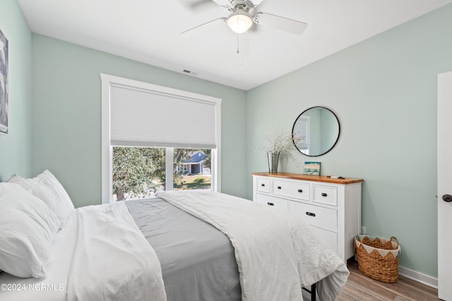 bedroom with ceiling fan and light wood-type flooring